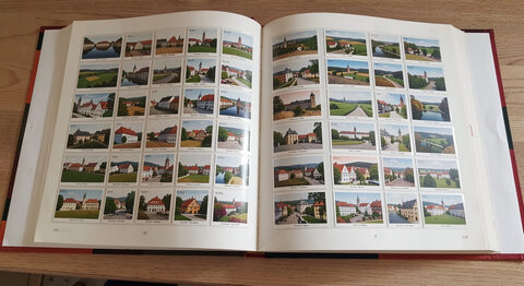 An open album page with topographical postcards of a Czech town arranged in neat rows.
